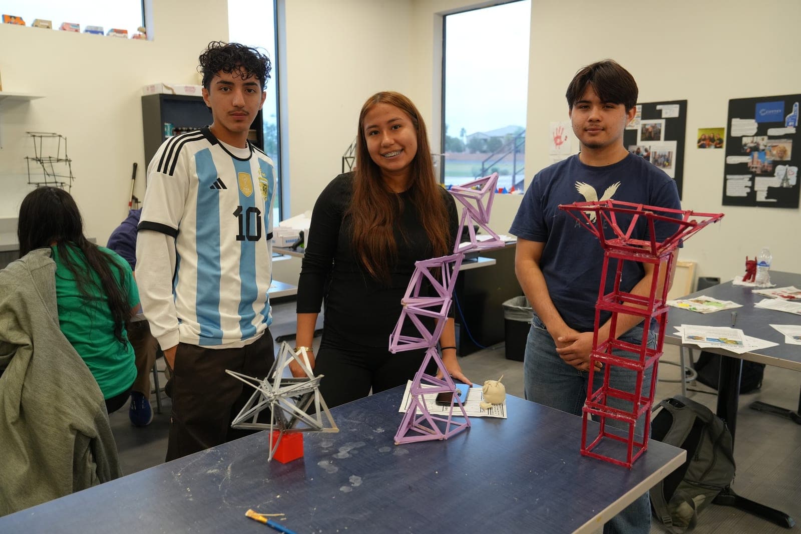 Highland Prep West students displaying the structural towers they designed and built